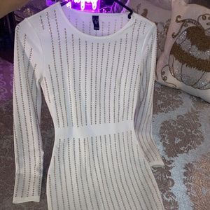 White, long sleeve dress, with a gold metallic design..